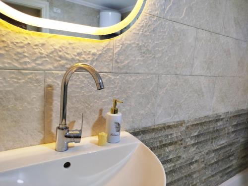 a sink with a faucet in a bathroom at Royal central home Cairo in Cairo
