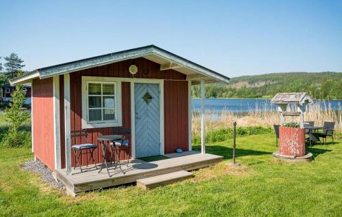 a tiny house with a porch and a table and chairs at Nice Home In Kramfors in Kramfors