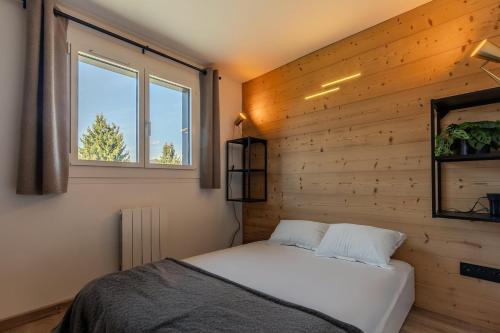 Ένα ή περισσότερα κρεβάτια σε δωμάτιο στο Appartement avec superbe vue montagne