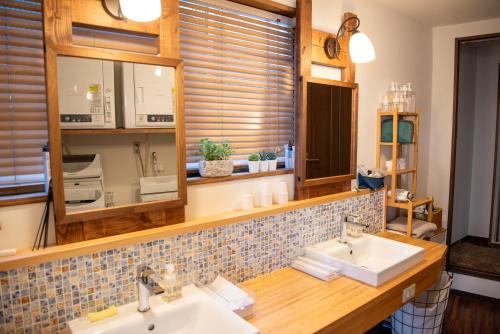 a bathroom with two sinks and a mirror at Shimanto Hutte in Shimanto-cho