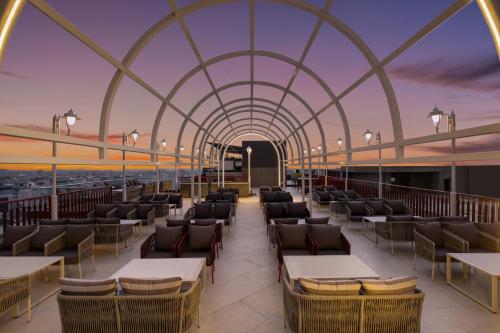 a rendering of a restaurant with tables and chairs at Keys Prima by Lemon Tree Hotels, Kota, Rajasthan in Kota