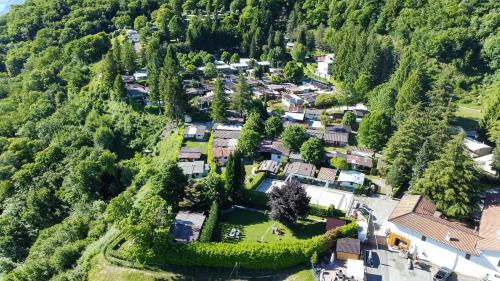 an aerial view of a small village in the mountains at Campeggio Internazionale Madonna del Ghisallo in Magreglio
