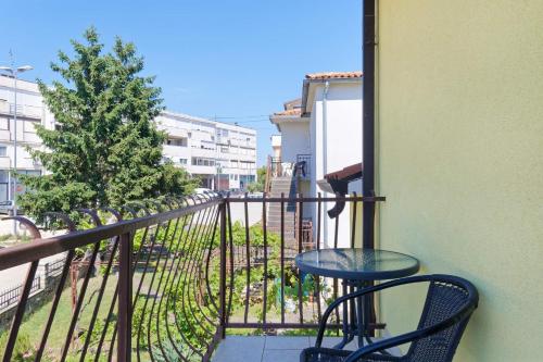 a table and chair on a balcony with a view at Studio Apartments Nada in Umag