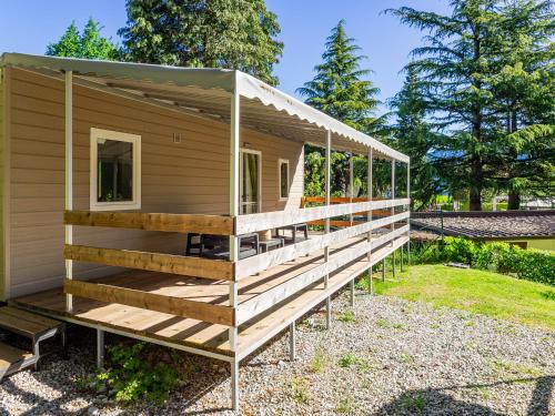 a house with a large deck on the side of it at Campeggio Internazionale Madonna del Ghisallo in Magreglio