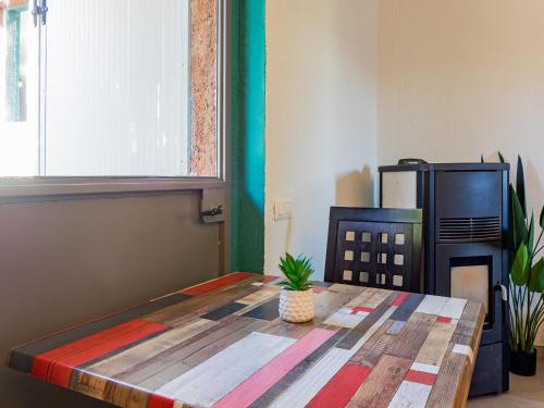 a room with a table and a refrigerator at Campeggio Internazionale Madonna del Ghisallo in Magreglio