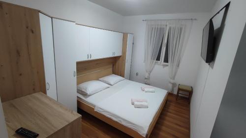 a bedroom with a bed with two towels on it at Laura in Koromačno