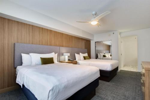 a hotel room with two beds and a mirror at Homewood Suites by Hilton Louisville-East in Louisville