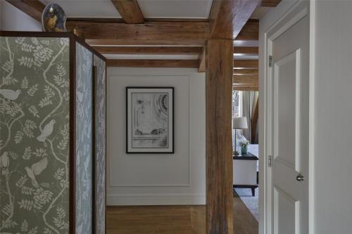 a hallway with wood ceilings and a framed picture at Waldorf Astoria Amsterdam in Amsterdam