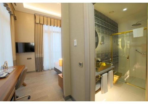 a bathroom with a sink and a shower in a room at Tryp by Wyndham Istanbul Topkapi in Istanbul