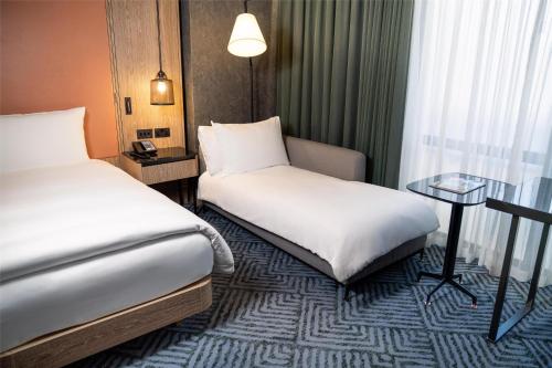 a hotel room with two beds and a table at Hilton London Bankside in London