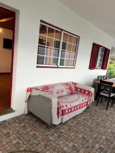 a couch with a face on it sitting in a room at Casa da Vinha in Feteira