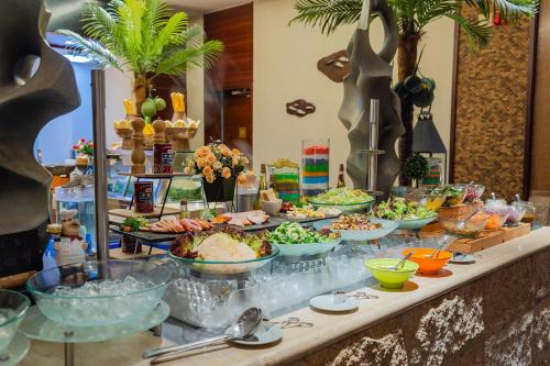 a buffet with many dishes of food on a table at Four Points by Sheraton Shenzhou Peninsula Resort in Wanning