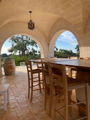a large dining room with a table and chairs at B&B Lamascopone in Fasano