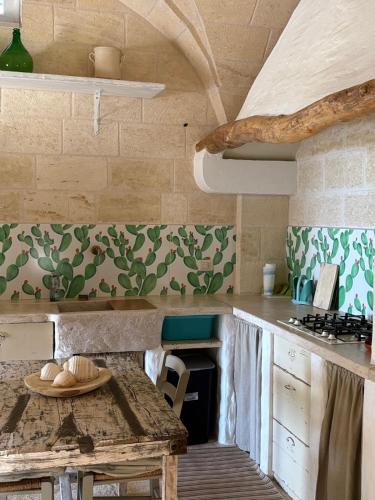 a kitchen with a table and a counter top at B&B Lamascopone in Fasano