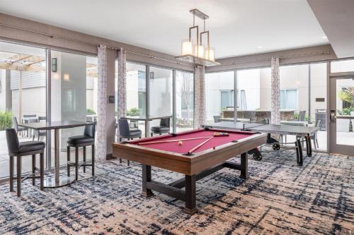 a pool table in a room with windows at Homewood Suites By Hilton San Jose Santa Clara in San Jose