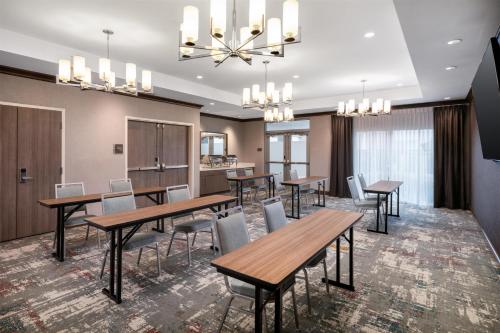 a dining room with wooden tables and chairs at Homewood Suites By Hilton San Jose Santa Clara in San Jose