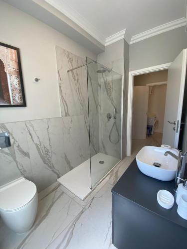 a bathroom with a shower and a toilet and a sink at La Quiete Lesa in Lesa