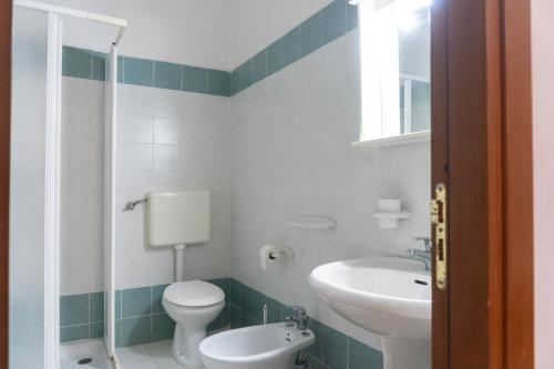 a bathroom with a toilet and a sink at Casa Vacanze Il Sole in Casamassella