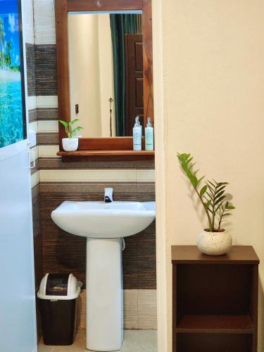 a bathroom with a sink and a mirror at La Breeze in Arugam Bay