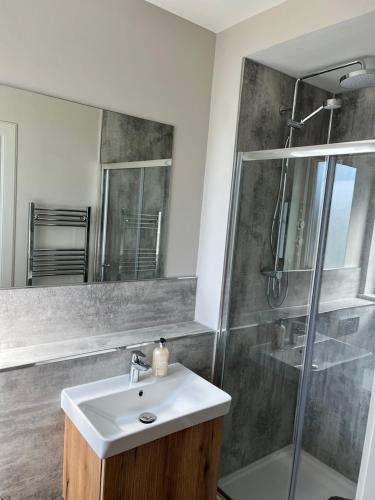 a bathroom with a sink and a shower at Dune House, Golf Road, Dornoch 5x Bedrooms in Dornoch