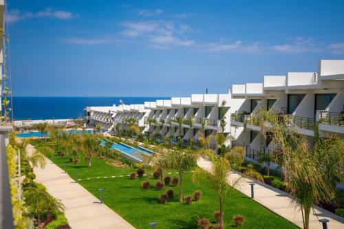 an apartment building with a swimming pool and a resort at Beautiful Apartment in charming area in Bahçeli