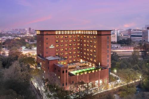 a rendering of a building with lights on it at Holiday Inn Gurgaon NH8 by IHG in Gurgaon