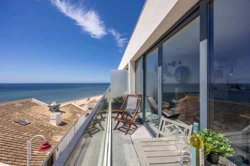 a balcony of a house with a view of the ocean at Frontline Seaview Apartment in Budens