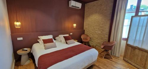 a bedroom with a large bed in a room at La Sauternaise, luxury Boutique B&B in Sauternes