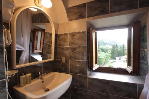a bathroom with a sink and a window at I Giardini di Marcello in Dicomano