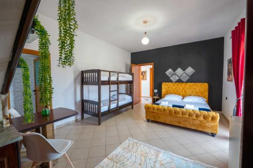 a bedroom with two bunk beds and a couch at Vila Eden in Ksamil