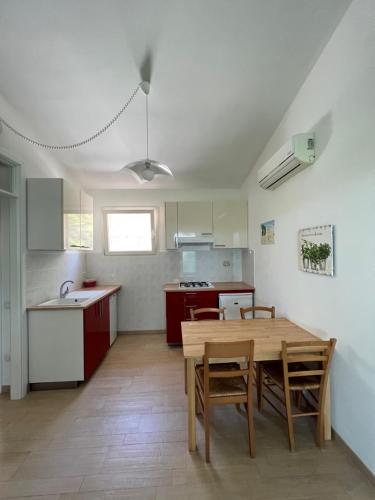 a kitchen and dining room with a table and chairs at Casa Campanella Resort in Capoliveri