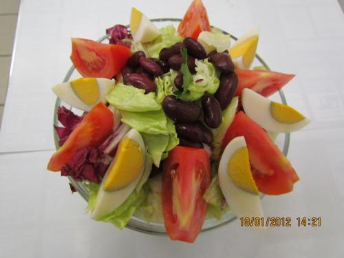 a salad with beans and vegetables in a glass bowl at Črni Baron Pension Black Baron in Maribor