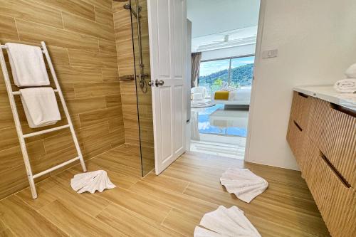 a bathroom with a shower and towels on the floor at Magnifique Vue Mer - Villa Hidden Paradise Samui in Bophut 