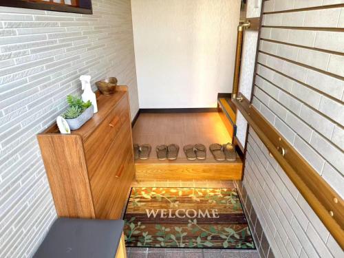 a hallway with a welcome sign on the floor at TOKYO HOSHI VILLIA-Private Villa in Tokyo ideal for groups and families in Tokyo