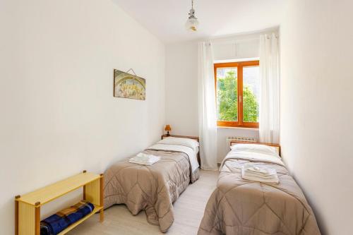 Una cama o camas en una habitación de I Due Gelsi appartamento Wood