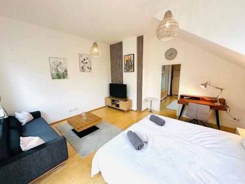 a living room with a bed and a couch at 1 Min to Metro I Balcony I 20 Min to Inner City in Vienna
