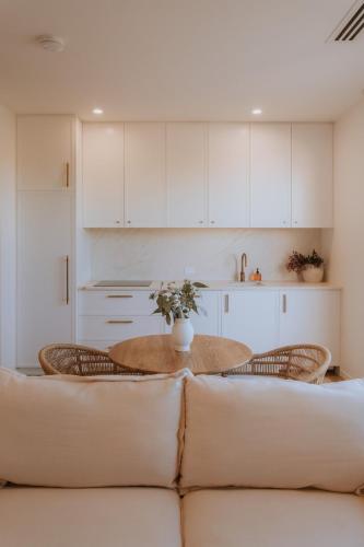 a living room with a couch and a table at Villa Alora in Exmouth