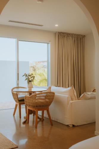 a living room with a white couch and a table at Villa Alora in Exmouth