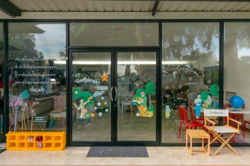 a store front with glass doors with toys in it at Baan Phing Phu Praew Cha-Am Resort บ้านพิงภูแพรว รีสอร์ท ชะอำ in Cha Am