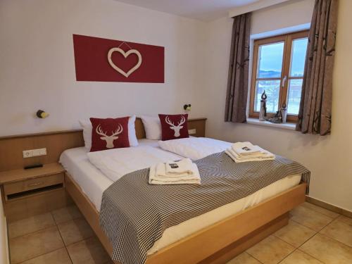 a bedroom with a bed with two towels on it at Ferienhof Haug in Rieden am Forggensee