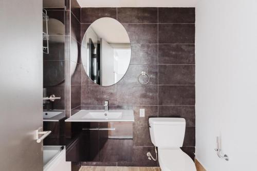 a bathroom with a white toilet and a mirror at Blueground Downtown Brooklyn rooftop nr Fort Greene Park NYC-1832 in Brooklyn