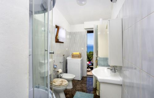 a white bathroom with a toilet and a sink at Casa Silente Opatija by Villas Guide in Lovran