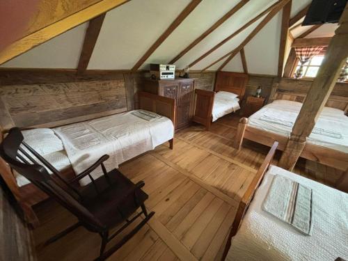 an overhead view of a bedroom with two beds and a chair at Brvnara "Duboki Potok" in Vrnjačka Banja
