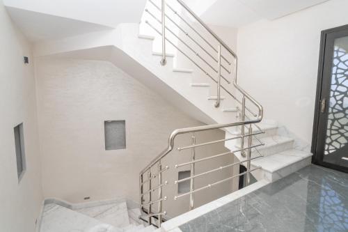 a staircase in a house with white walls at Villa Ibn Batouta piscine 8x3 sans vis a vis in Tangier