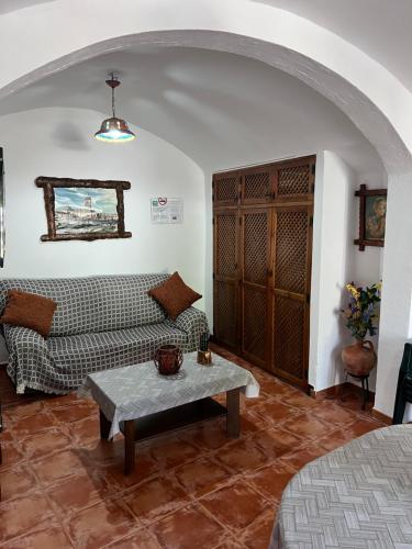 a living room with a couch and a table at Cueva de María 1 in Guadix
