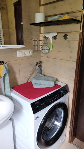 a washer and dryer in a tiny house at Ferienhaus Altenstrasser in Philippsreut