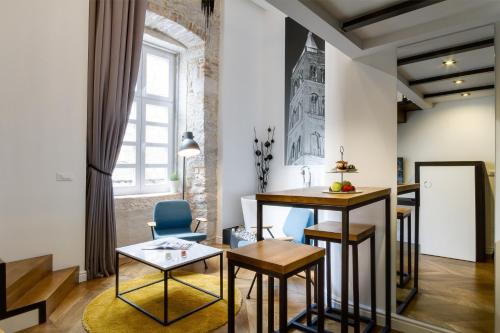 a living room with a table and chairs at DeZign Superior Apartments & Rooms in Zadar