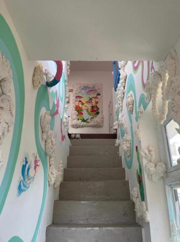 a staircase in a room with colorful walls at Art Guesthouse and Rooftop in Seoul