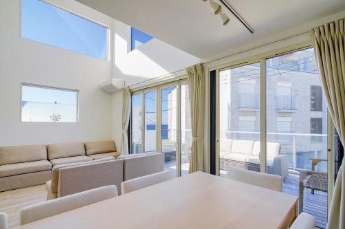 a living room with a table and chairs at Hayama Morito Beach Seascape Villa - 葉山 森戸海岸 Seascape Villa in Hayama