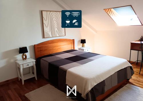 a bedroom with a bed and a sign on the wall at MyStay - Casa Sete Lano in Pedrógão